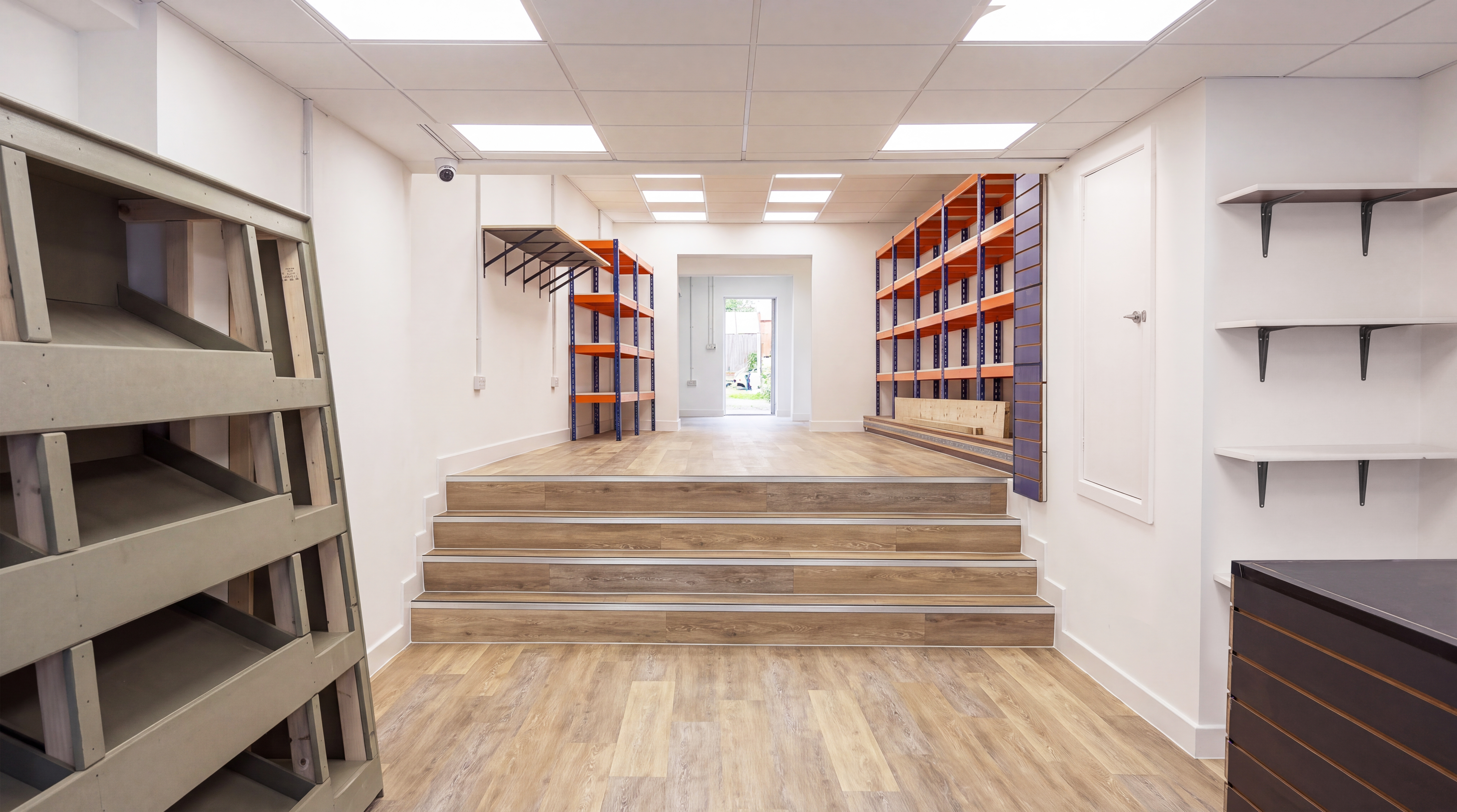 The same room after a complete Allphase renovation with new flooring, shelving and lighting